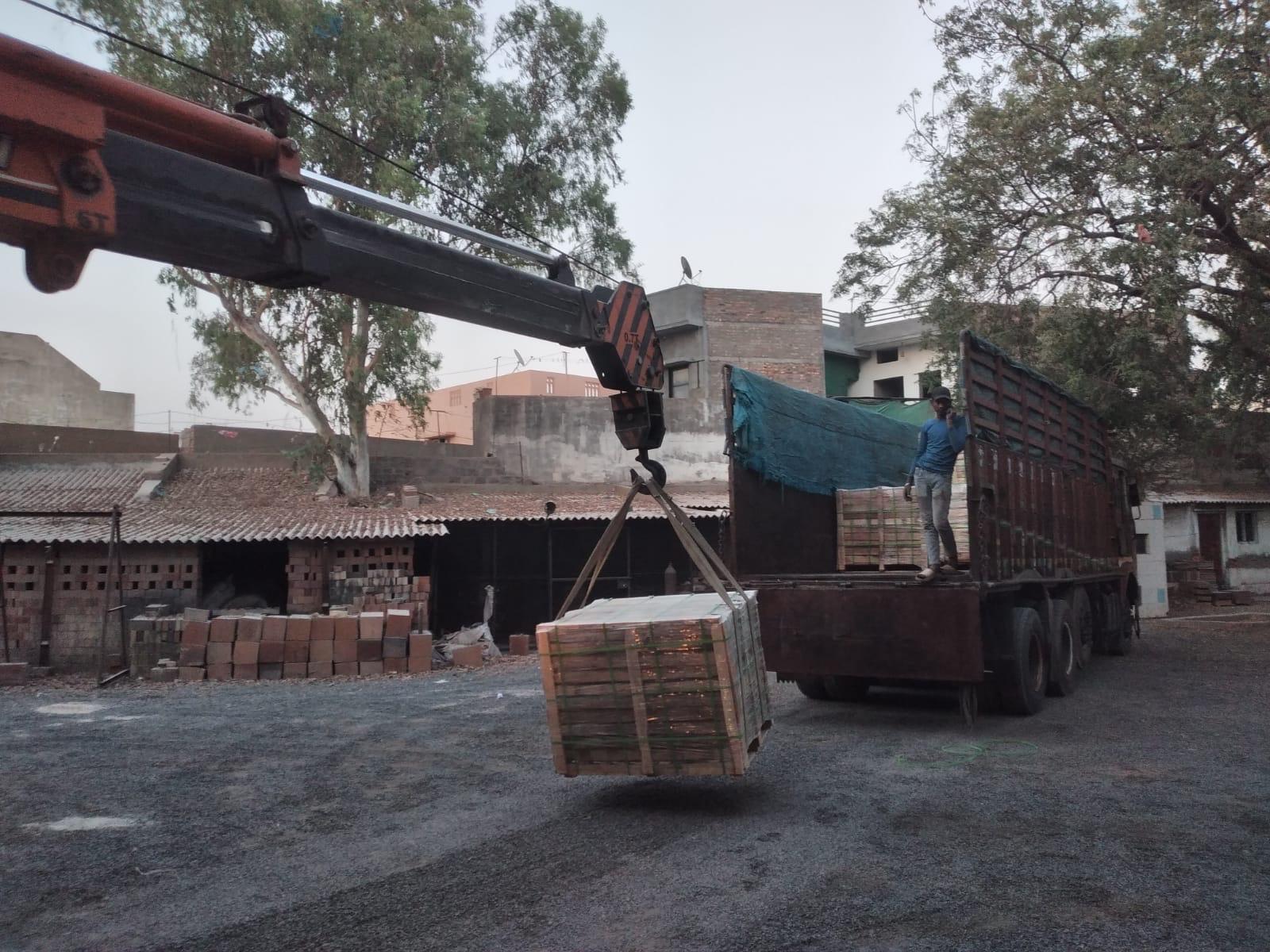 Packed plastic refractory shipment being handled by a truck-mounted crane